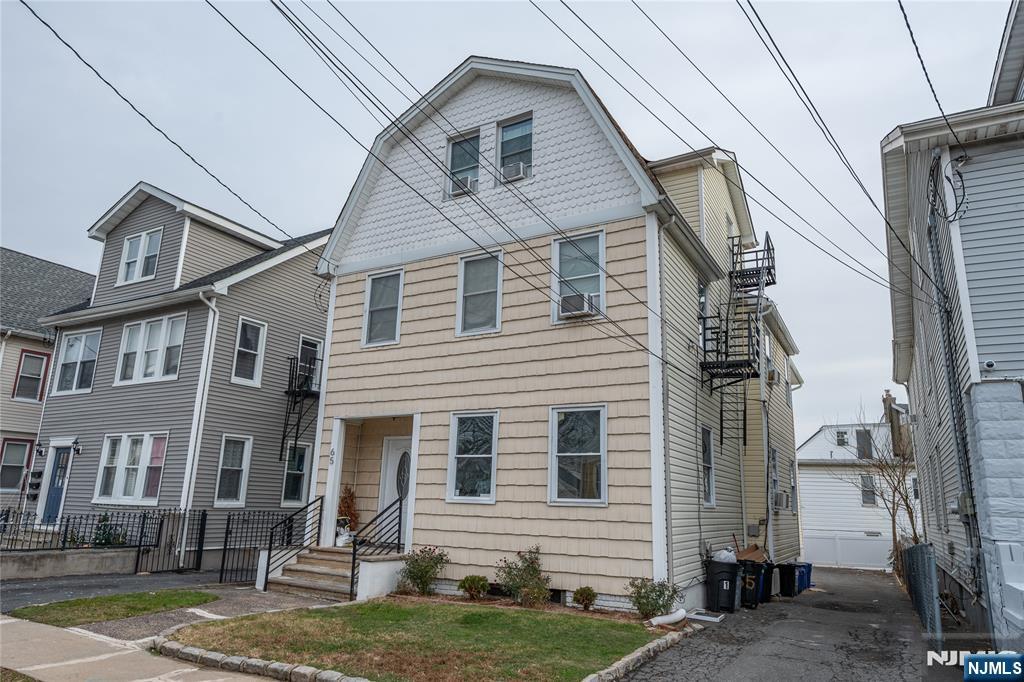 65 Grove Street Bloomfield, NJ 07003 - Photo 49 of 50 a view of a white house next to a yard