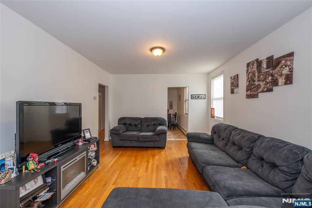 65 Grove Street Bloomfield, NJ 07003 - Photo 6 of 50 a living room with furniture and a flat screen tv