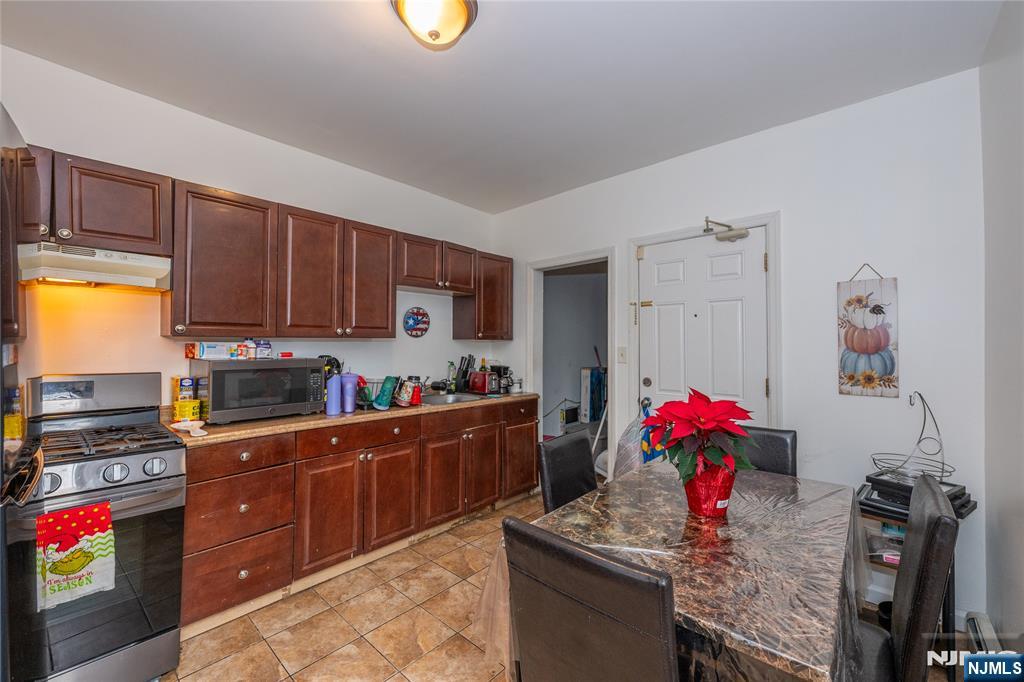 65 Grove Street Bloomfield, NJ 07003 - Photo 7 of 50 a kitchen that has a lot of cabinets a sink and a stove in it