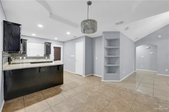 a kitchen with a sink stainless steel appliances and cabinets