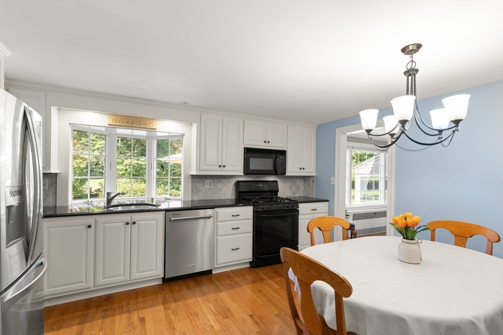 148 Ipswich Road Boxford, MA 01921 - Photo 16 of 42 a kitchen with granite countertop a sink stainless steel appliances and windows