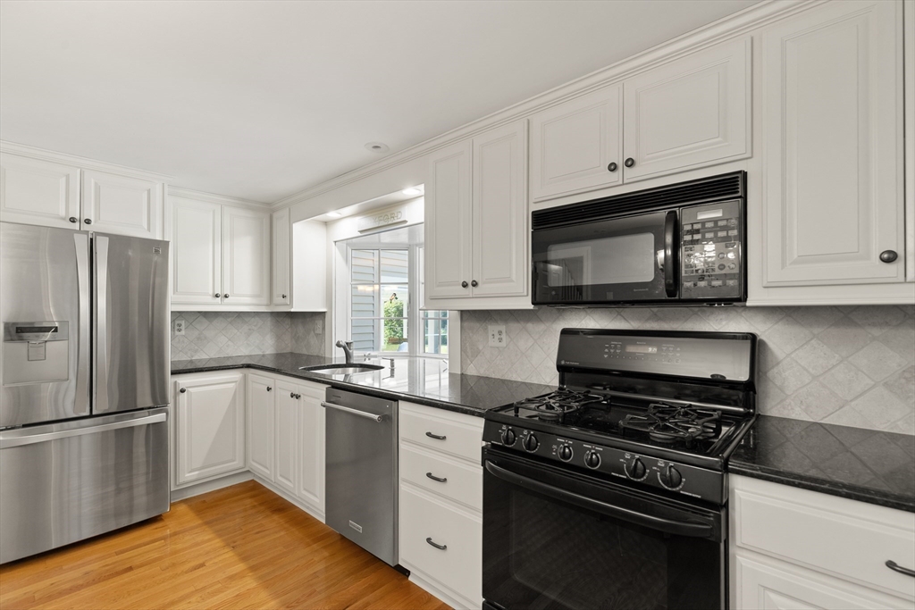148 Ipswich Road Boxford, MA 01921 - Photo 17 of 42 a kitchen with granite countertop white cabinets and stainless steel appliances