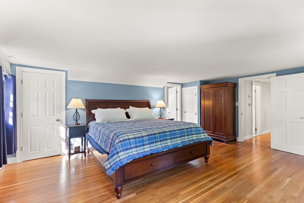 148 Ipswich Road Boxford, MA 01921 - Photo 28 of 42 a bedroom with a bed and wooden floor