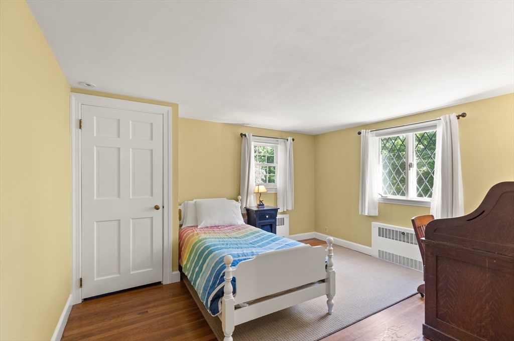 148 Ipswich Road Boxford, MA 01921 - Photo 31 of 42 a bedroom with a bed and wooden floor