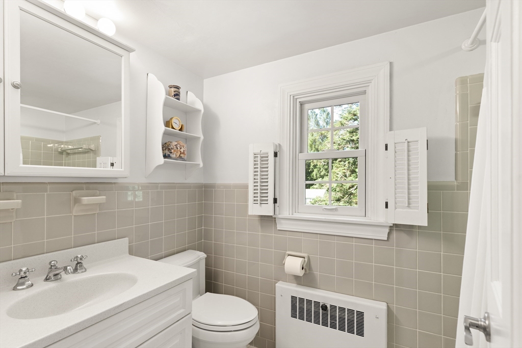 148 Ipswich Road Boxford, MA 01921 - Photo 32 of 42 a bathroom with a toilet a sink a window and mirror