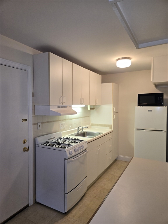 6 Venice Street, Unit F2 Danvers, MA 01923 - Photo 3 of 19 a kitchen with stainless steel appliances granite countertop a stove a sink and a refrigerator