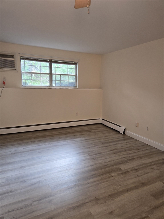 6 Venice Street, Unit F2 Danvers, MA 01923 - Photo 8 of 19 a view of a room with wooden floor and window
