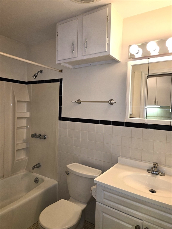 6 Venice Street, Unit F2 Danvers, MA 01923 - Photo 10 of 19 a bathroom with a sink a toilet and shower