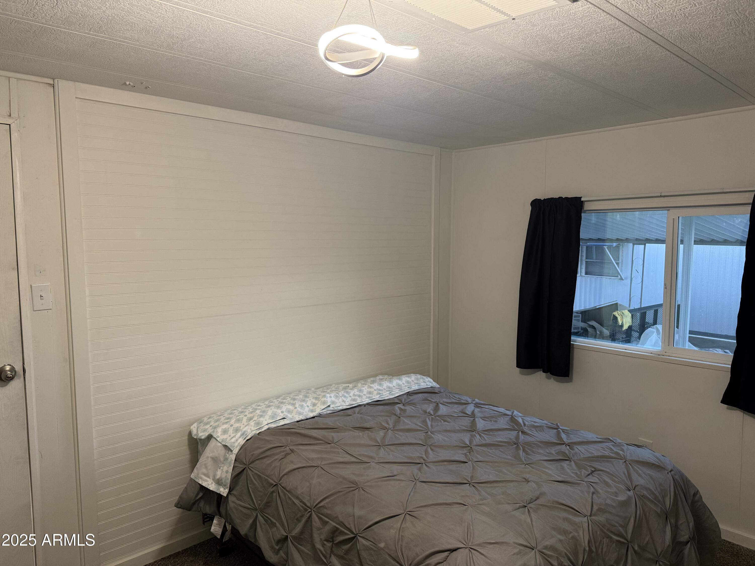 16005 North 32nd Street, Unit 66 Phoenix, AZ 85032 - Photo 7 of 7 a bedroom with a bed and a mirror