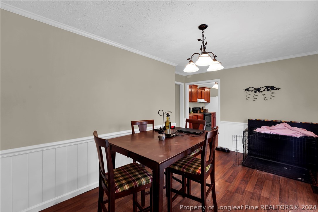 480 Rockfish Road Raeford, NC 28376 - Photo 11 of 30 a dining room with wooden floor and breakfast area