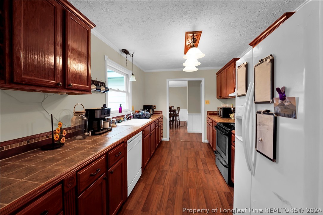 480 Rockfish Road Raeford, NC 28376 - Photo 14 of 30 a kitchen with lots of counter space and wooden floor