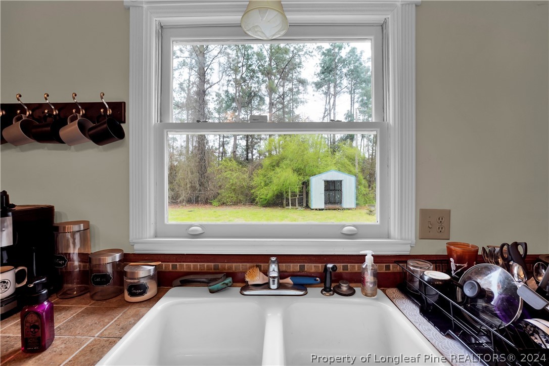 480 Rockfish Road Raeford, NC 28376 - Photo 16 of 30 a room with furniture and a floor to ceiling window