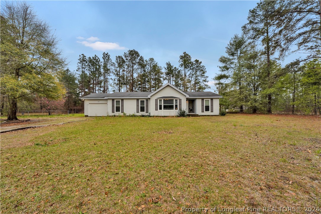 480 Rockfish Road Raeford, NC 28376 - Photo 2 of 30 a house with trees in front of it
