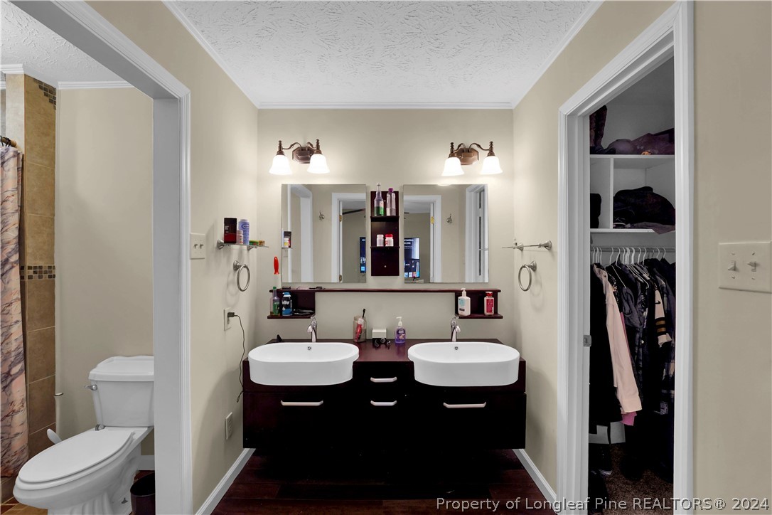 480 Rockfish Road Raeford, NC 28376 - Photo 27 of 30 a bathroom with a sink toilet and shower