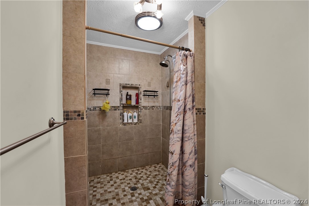 480 Rockfish Road Raeford, NC 28376 - Photo 28 of 30 a bathroom with a shower and a toilet