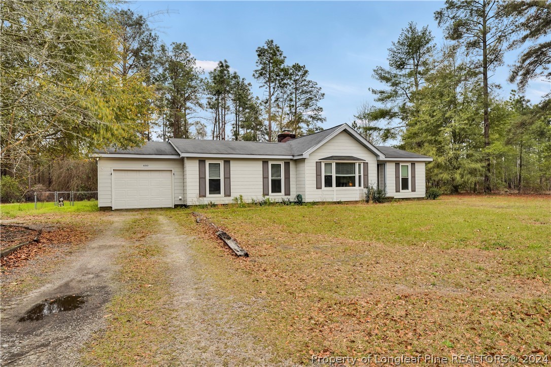 480 Rockfish Road Raeford, NC 28376 - Photo 4 of 30 a front view of a house with a yard and trees