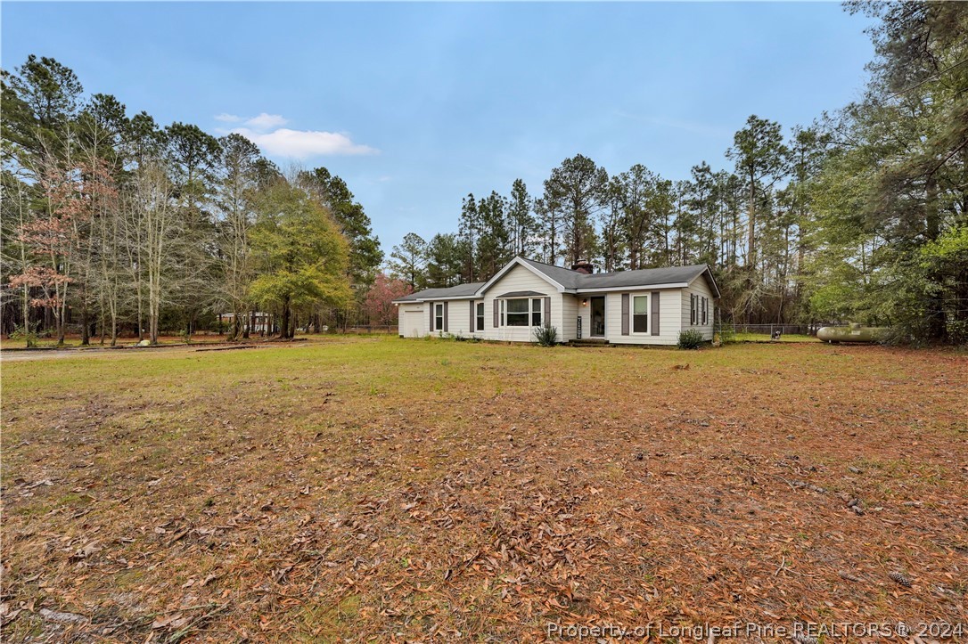 480 Rockfish Road Raeford, NC 28376 - Photo 5 of 30 a house view with swimming pool in front of it