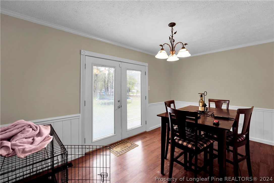 480 Rockfish Road Raeford, NC 28376 - Photo 10 of 30 a view of a dining room with furniture wooden floor and a chandelier
