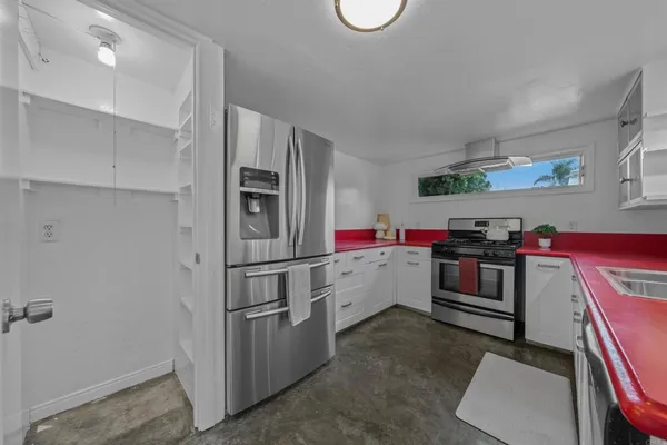 a kitchen with refrigerator and window