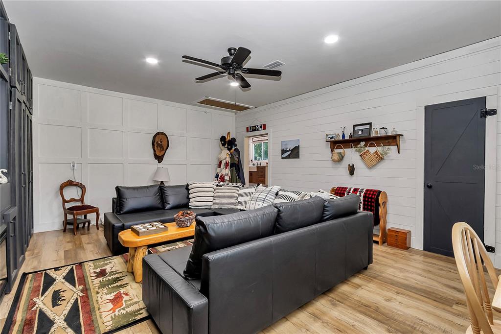 13232 Northeast 39th Terrace Anthony, FL 32617 - Photo 19 of 55 a living room with furniture and a flat screen tv