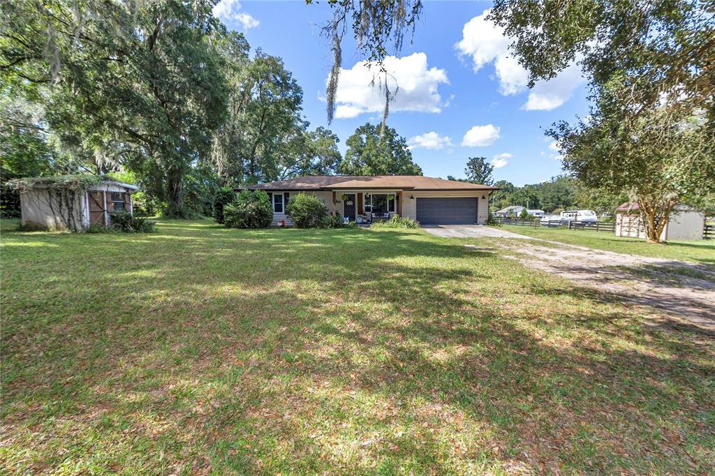 13232 Northeast 39th Terrace Anthony, FL 32617 - Photo 2 of 55 a front view of house with yard and trees around