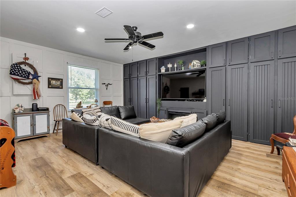 13232 Northeast 39th Terrace Anthony, FL 32617 - Photo 21 of 55 a living room with furniture and a flat screen tv