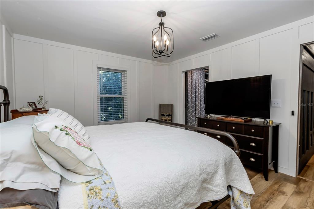 13232 Northeast 39th Terrace Anthony, FL 32617 - Photo 28 of 55 a bedroom with a bed and a flat screen tv