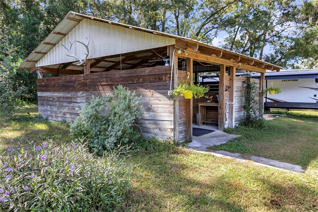 13232 Northeast 39th Terrace Anthony, FL 32617 - Photo 37 of 55 a view of a house with a yard potted plants and a ceiling tree