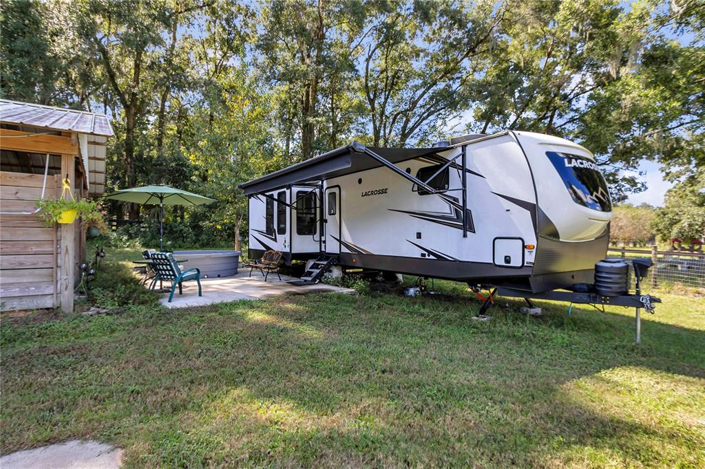 13232 Northeast 39th Terrace Anthony, FL 32617 - Photo 45 of 55 a house view with a sitting space and garden