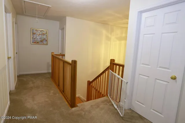a view of a hallway with staircase
