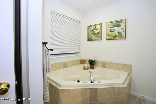 a bath tub sitting next to a bathroom sink