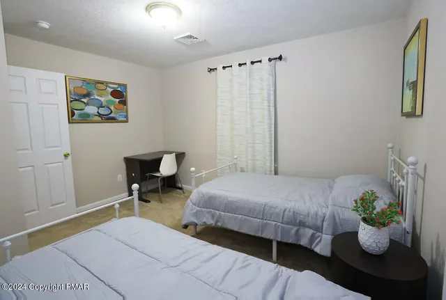 a bedroom with bed and a window