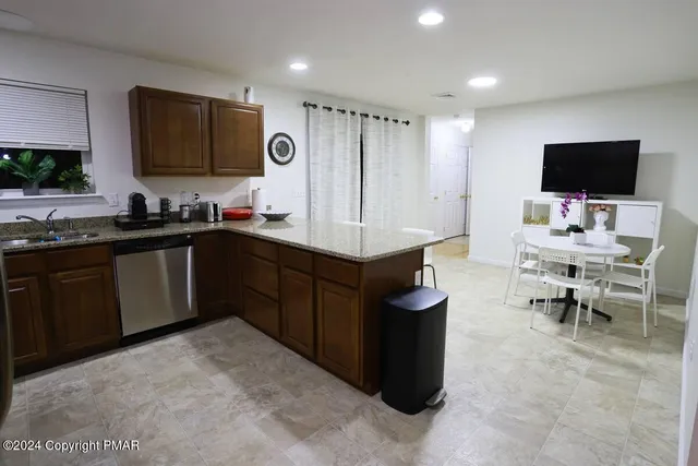 a kitchen with a sink and a refrigerator