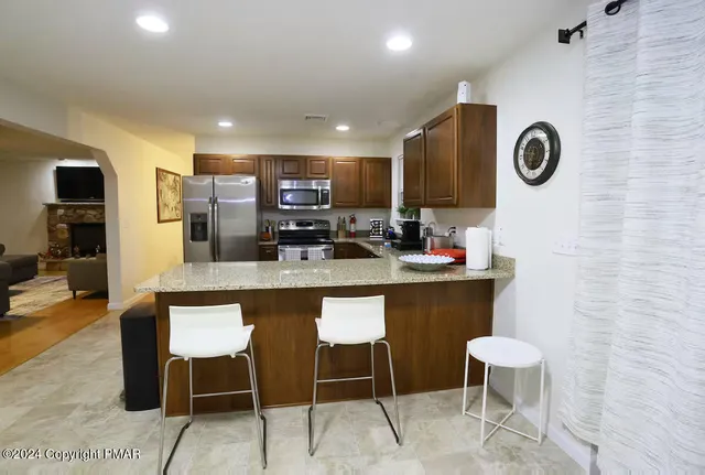 a kitchen with a table and chairs in it