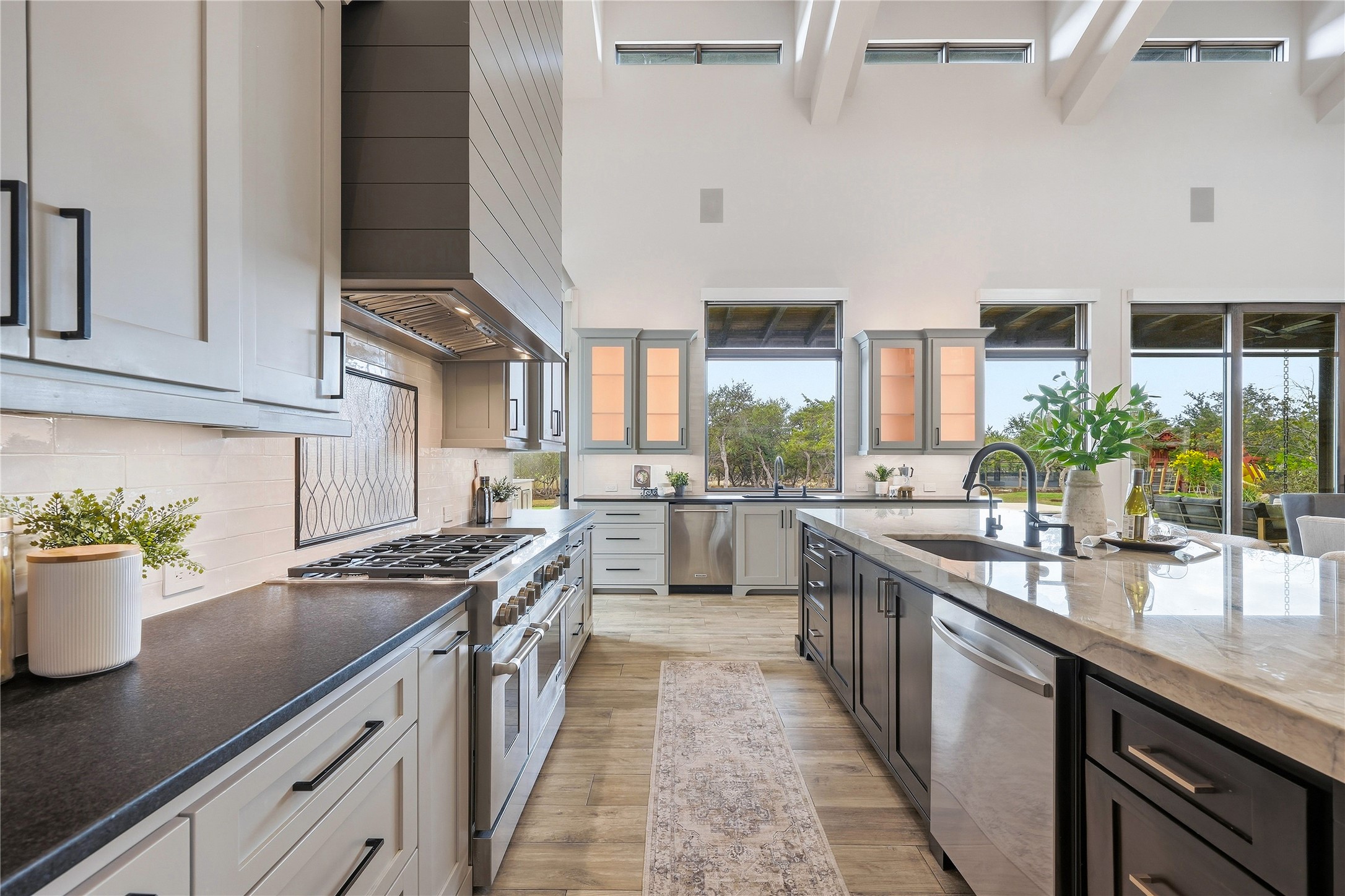 449 Ranch Falls Fair Oaks Ranch, TX 78015 - Photo 10 of 39 A spacious culinary space highlights vaulted beamed ceilings above contrasting dark and light cabinetry.