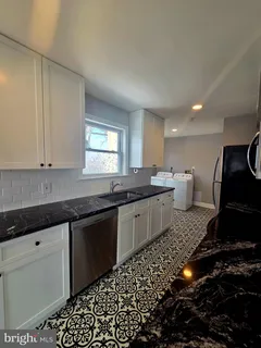 a kitchen with a sink and cabinets