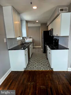 a kitchen with a sink and cabinets