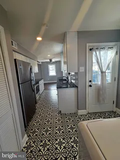 a view of a bathroom with a sink a window and wooden floor