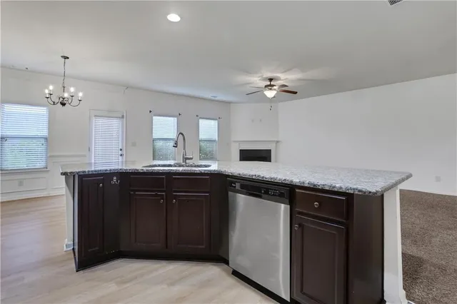 a kitchen with a sink a stove and cabinets