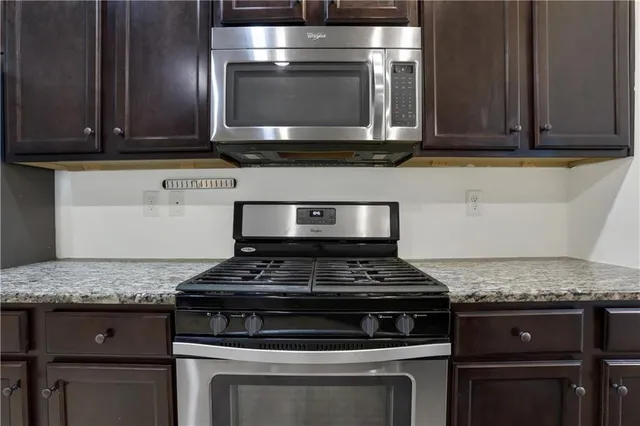 a stove top oven sitting inside of a kitchen