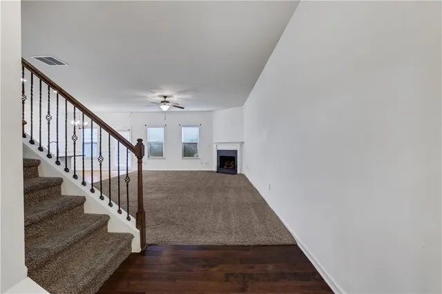 a view of entryway and hall with wooden floor