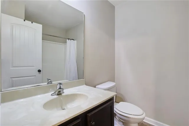 a bathroom with a sink a toilet and mirror