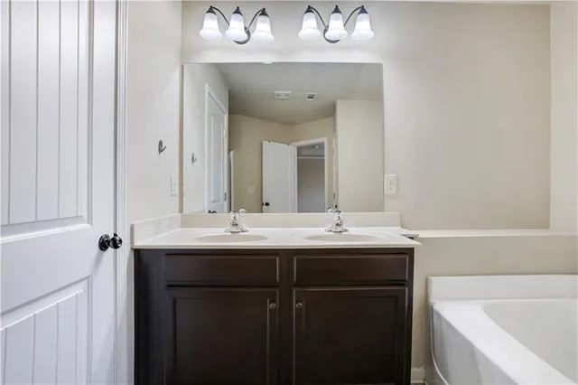 a bathroom with a double vanity sink and a mirror