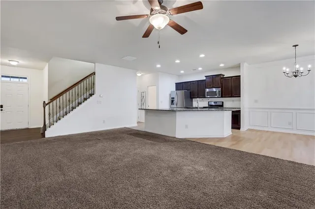 a view of a kitchen with a sink and a ceiling fan