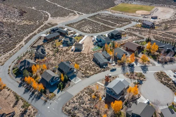 an aerial view of residential houses with outdoor space