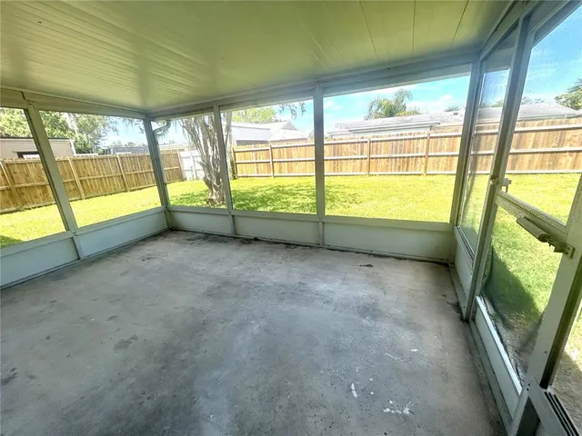 a view of an empty room with a large window