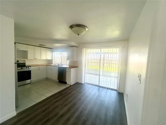 a view of a kitchen with a sink and wooden floor
