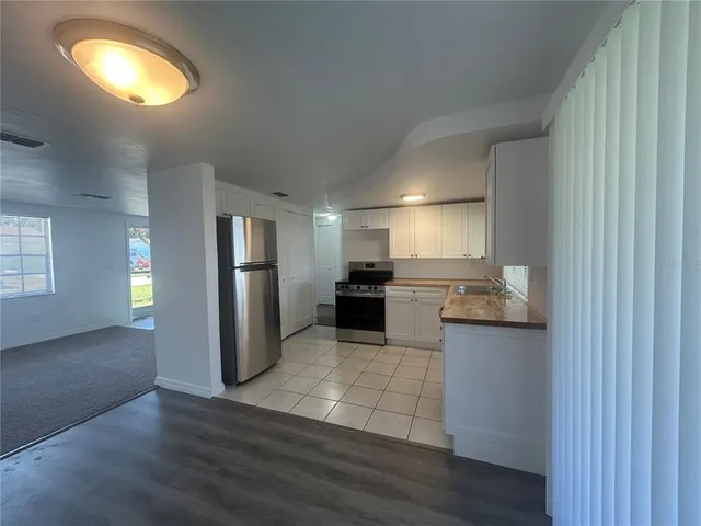 a kitchen with stainless steel appliances granite countertop a refrigerator and a stove top oven