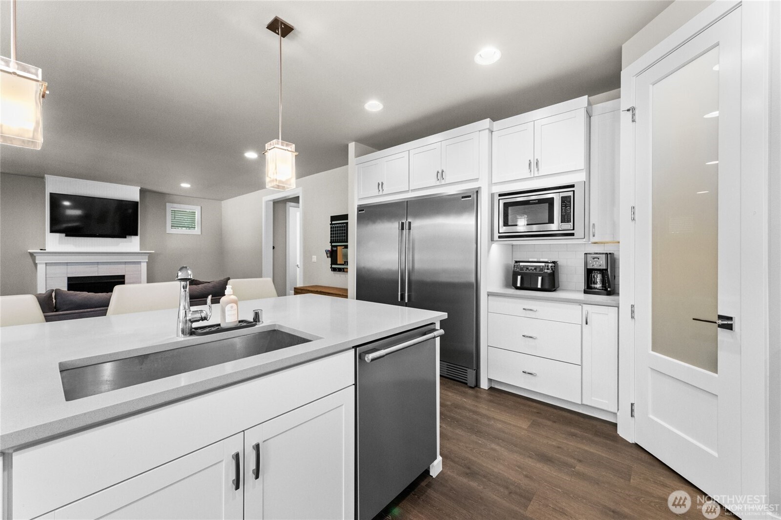 7780 53rd Place Gig Harbor, WA 98335 - Photo 11 of 39 a kitchen with white cabinets and stainless steel appliances