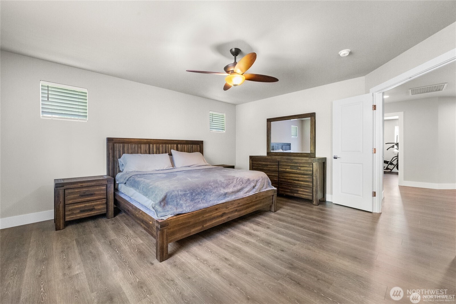 7780 53rd Place Gig Harbor, WA 98335 - Photo 14 of 39 a bedroom with a bed and a chandelier
